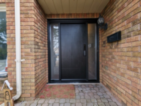 Modern mahogany fiberglass entry door with horizontal grooves and clear sidelights installed by MapleFort in Aurora.