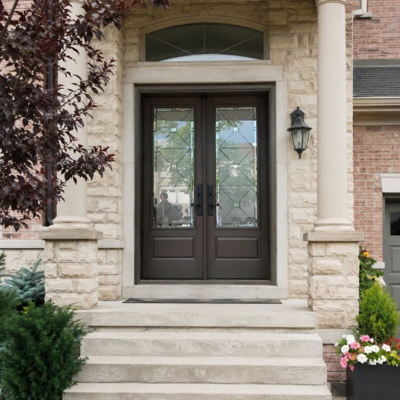 F49 fiberglass double entry door with decorative glass installed on a Canadian home entrance