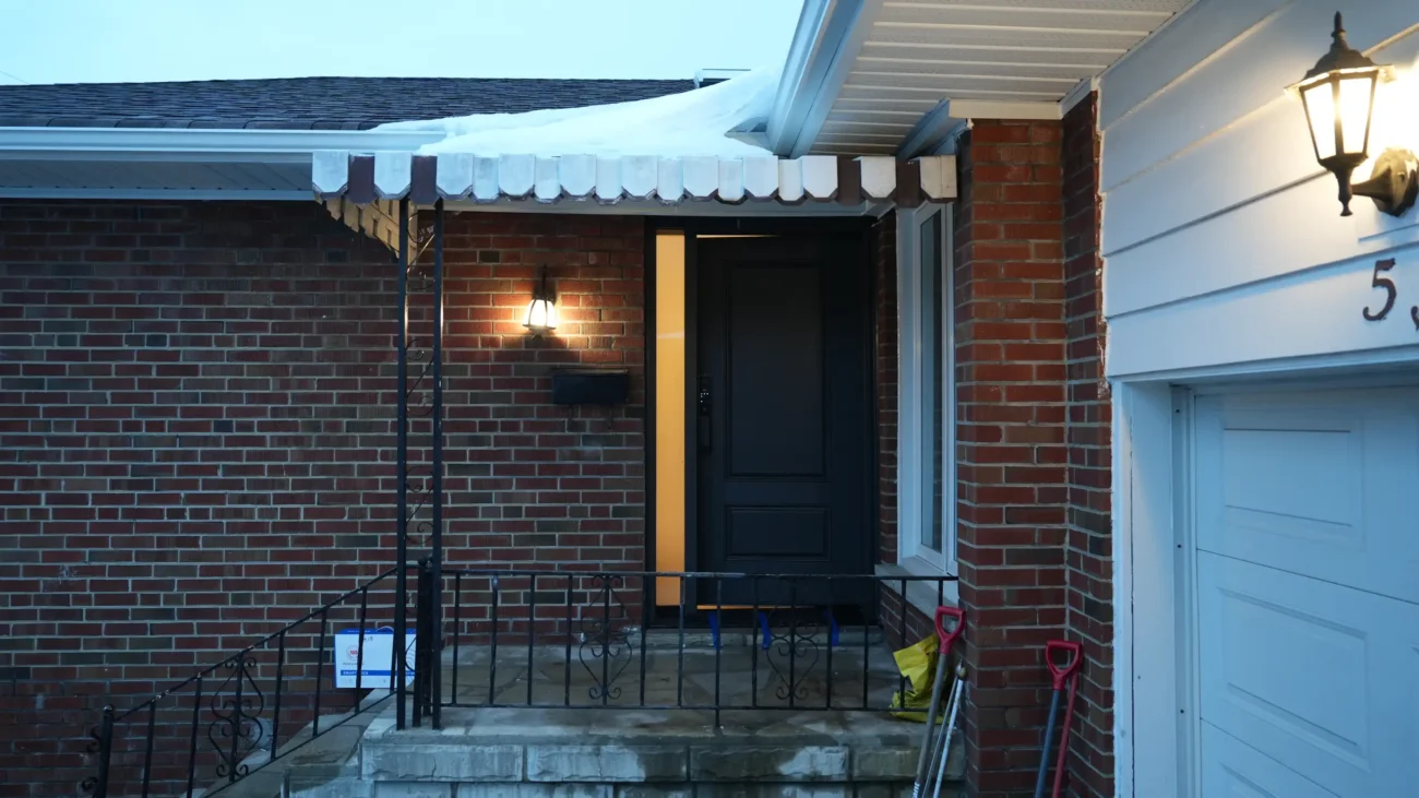 Dedicated MapleFort installer finishing a dark mahogany fiberglass entry door installation at dusk on Beacham Crest.