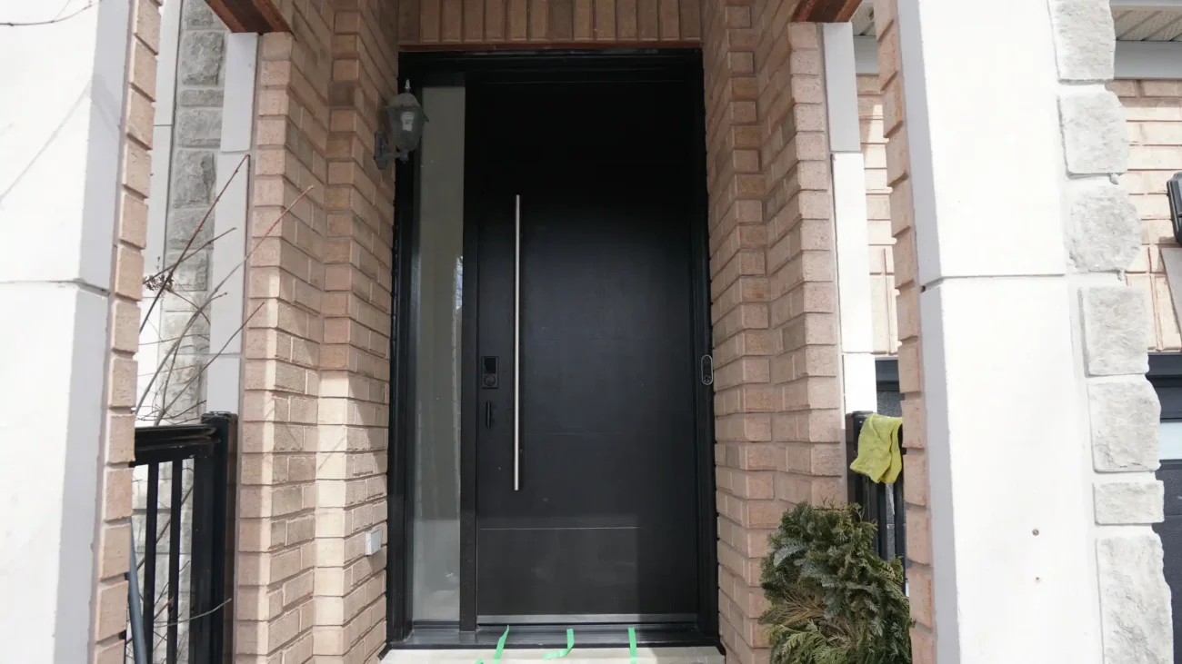 Modern dark mahogany fiberglass entry door with horizontal grooves and a multi-point lock system installed in Bradford.