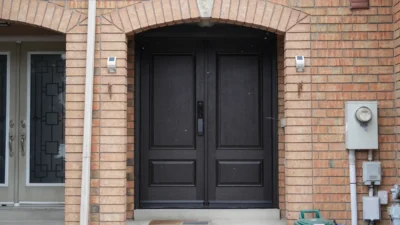 Modern solid dark mahogany fiberglass double entry doors installed by MapleFort during a spring snowstorm in Richmond Hill.