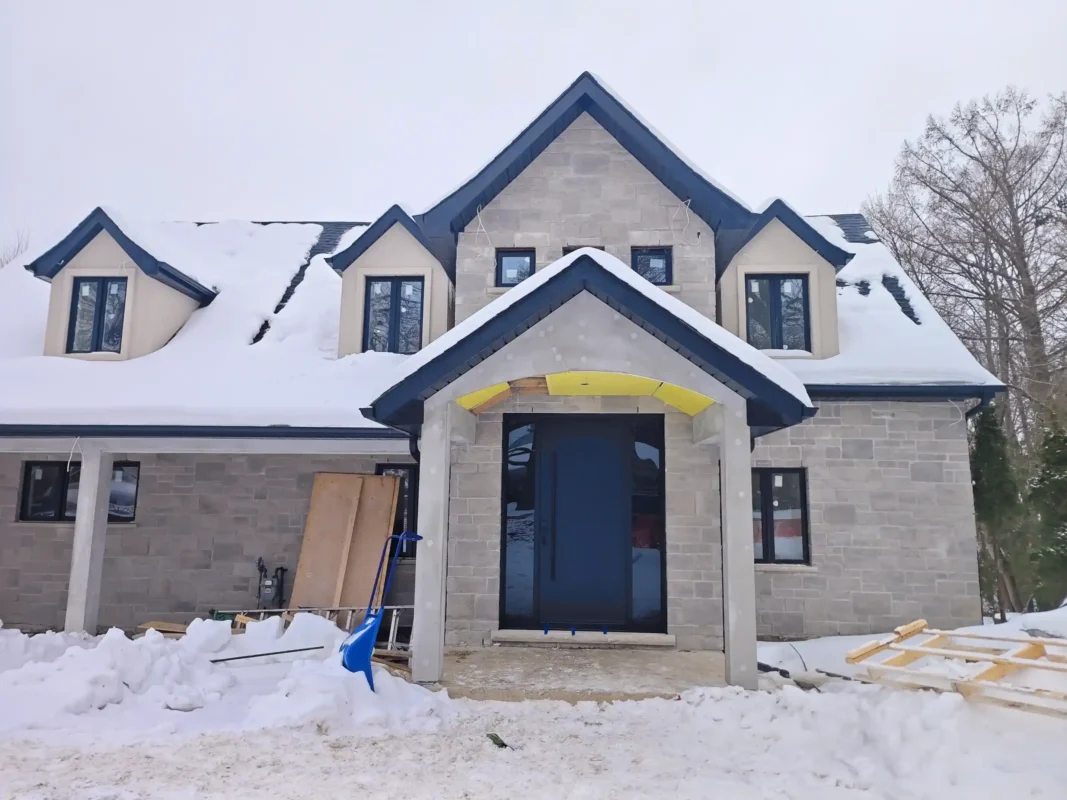 Modern dark mahogany fiberglass entry door with horizontal grooves installed by MapleFort on a snowy winter day in Newmarket.