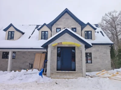 Modern dark mahogany fiberglass entry door with horizontal grooves installed by MapleFort on a snowy winter day in Newmarket.