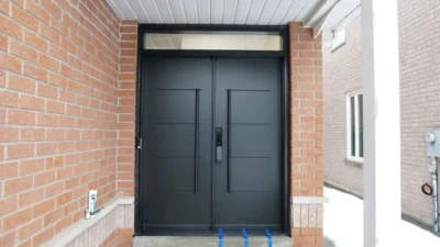 Modern black steel double entry doors installed by MapleFort in Richmond Hill during winter.