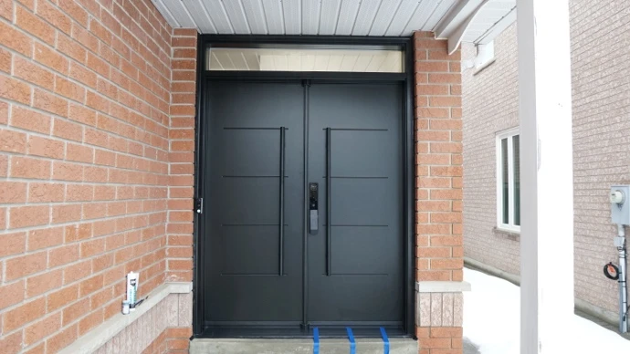 Modern black steel double entry doors installed by MapleFort in Richmond Hill during winter.