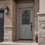 S65 steel entry door installed on a Canadian stone home entrance