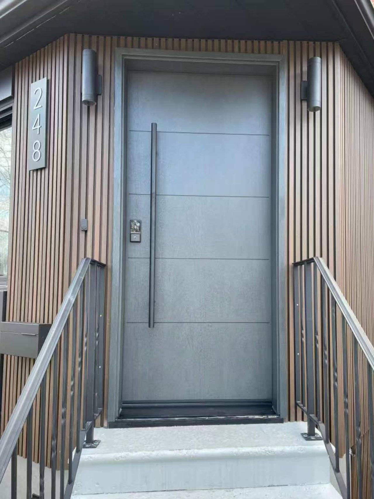 Modern front door installation in the GTA with a full-height charcoal entry door